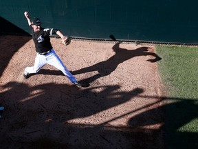 FILE - In this March 2, 2018 file photo, Chicago White Sox relief pitcher Danny Farquhar warms up in the bullpen during the sixth inning of the team's spring training baseball game against the Los Angeles Dodgers in Glendale, Ariz. Farquhar was taken to a hospital after he passed out in the dugout in the sixth inning of Chicago's 10-0 loss Friday, April 20, creating a scary scene as he was helped by medical professionals and the rest of the White Sox.