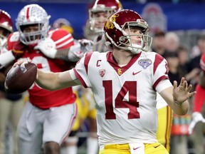FILE - In this Dec. 29, 2017, file photo, Southern California quarterback Sam Darnold (14) throws a pass with teammates providing blocking against Ohio State during the first half of the Cotton Bowl NCAA college football game in Arlington, Texas. Every quarterback prospect in the upcoming NFL draft has a major flaw or drawback that keeps them from being the consensus best one of the bunch.