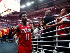 FILE - In this April 21, 2018, file photo, New Orleans Pelicans guard Jrue Holiday greets fans after the Pelicans defeated the Portland Trail Blazers 131-123 in Game 4 of a first-round NBA basketball playoff series in New Orleans. The Pelicans swept the series. In addition to being content with his family life and career trajectory, he's also about as healthy as he's been in half a decade, and his team is in the playoffs for the first time since 2015. Now he can focus purely on winning, and being as feisty as it takes to do so.