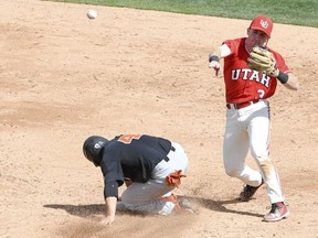 Utah second baseman Oliver Dunn completes a double play against Oregon State during an NCAA college baseball game in Salt Lake City, Utah, Saturday, March 31, 2018. A Utah team that opened the season 0-13 pulled the upset of the college baseball season, winning two of three against top-ranked Oregon State.