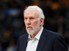FILE - In this Feb. 23, 2018, file photo, San Antonio Spurs head coach Gregg Popovich watches in the second half of an NBA basketball against the Denver Nuggets, in Denver. The NBA is paying tribute to the wife of San Antonio Spurs coach Gregg Popovich. Erin Popovich died Wednesday, April 18, 2018,  at 67, the team said. Her death came after a long illness, the San Antonio Express-News reported.