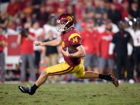 FILE - In this Oct. 14, 2017, file photo, Southern California quarterback Sam Darnold (14) runs with the ball during the second half of an NCAA college football game against Utah, in Los Angeles. Darnold is expected to be a first round pick in the NFL Draft.