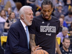 FILE - In this April 22, 2017, file photo, San Antonio Spurs head coach Gregg Popovich, left, talks with San Antonio Spurs forward Kawhi Leonard during the second half of Game 4 in an NBA basketball first-round playoff series against the Memphis Grizzlies, in Memphis, Tenn. The absolute unwillingness to answer certain questions is part of the San Antonio Spurs' mystique. The Spurs just don't share much. So there is some unmistakable irony here that when it comes to the obviously fractured relationship between San Antonio and Kawhi Leonard, it's the Spurs who are the ones frustrated by the lack of answers.