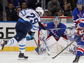 FILE - In this March 6, 2018, file photo, Winnipeg Jets right wing Patrik Laine (29), of Finland, shoots against New York Rangers goalie Henrik Lundqvist, of Sweden, during the second period of an NHL hockey game in New York. The Winnipeg Jets soared to the second-best record in the NHL this season, scoring more goals than any other team in the Western Conference behind one of the league's young stars in Patrik Laine.
