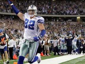 FILE - In this Oct. 25, 2010, file photo, Dallas Cowboys tight end Jason Witten holds the ball up as he scores a 4-yard touchdown against the New York Giants during the first quarter of an NFL football game, in Arlington, Texas. Witten plans to retire after 15 seasons and join ESPN as its lead analyst for the "Monday Night Football" broadcast, the network reported Friday, April 27, 2018.