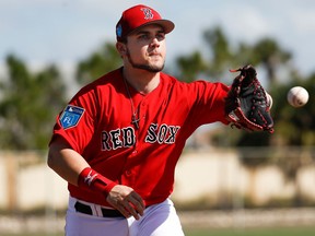FILE - Michael Chavis practices during Boston Red Sox baseball spring training in Fort Myers, Fla. Chavis, a third baseman taken by Boston with the 26th overall pick in the 2014 amateur draft, was suspended for 80 games under baseball's minor league drug program after testing positive for a performance-enhancing substance.