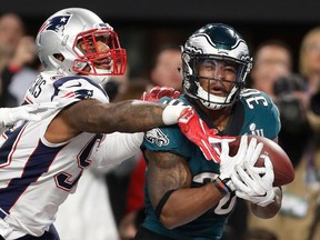 FILE - In this Feb. 4, 2018, file photo, Philadelphia Eagles' Corey Clement, right, catches a touchdown pass in front of New England Patriots' Marquis Flowers during the second half of the NFL Super Bowl 52 football game in Minneapolis. While first-round picks receive most of the attention and players chosen the first two days of the draft get more money and better job security, success on Day 3 of the draft often separates the elite teams from the good ones. That was evident when the Eagles and Patriots met in February. Corey Clement had 100 yards receiving and one touchdown and LeGarrette Blount ran for 90 yards and one touchdown in Philadelphia's 41-33 victory. Danny Amendola led the Patriots with 152 yards receiving and Chris Hogan had 128. All four players were undrafted free agents.