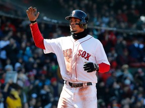 FILE - In this April 7, 2018, file photo, Boston Red Sox's Xander Bogaerts heads for the dugout after scoring against the Tampa Bay Rays during the first inning of a baseball game in Boston. Bogaerts was expected to return to the Red Sox lineup on Friday, April 27m for a homestand opener against Tampa Bay. Bogarts broke the talus bone in his left ankle on April 8 while sliding into the Rays dugout to grab an errant ball.