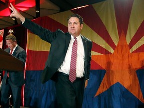 FILE - In this Nov. 4, 2014 file photo, Arizona Republican Attorney General Mark Brnovich waves to supporters at the Republican election night party in Phoenix. Minority Democrats in the Arizona Legislature have urged Brnovich to join the lawsuit challenging the citizenship question in the 2020 census. But his spokesman said that won't happen, just as he refused to sign onto the Republican letter urging the question be included in the census. "We have concerns this issue has been overly politicized," Brnovich spokesman Ryan Anderson said in a statement.