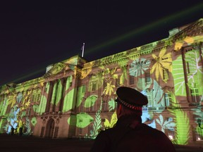 A Rainforest design is projected onto Buckingham Palace in London on Sunday, April 15, 2018, as part of the Queen's Commonwealth Canopy project (QCC), a global conservation initiative in the Queen's name which seeks to preserve precious areas of forest for future generations.