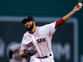 FILE - In this April 11, 2018, file photo, Boston Red Sox starting pitcher David Price delivers Fenway Park in Boston. Price, J.D. Martinez and the Boston Red Sox are doing road trips differently than ballplayers used to.