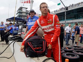 FILE - In this May 19, 2017, file photo, Sebastien Bourdais, of France, unpacks his helmet as he prepares to drive during a practice session for the Indianapolis 500 IndyCar auto race at Indianapolis Motor Speedway in Indianapolis. No matter the part, what Bourdais can do in a race car, and what kind of competitor he is at his core, have made it clear that he is still among the very elite at his craft.