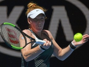 FILE - In this Jan. 16, 2018, file photo, United States' Madison Brengle makes a forehand return to Britain's Johanna Konta during their first-round match at the Australian Open tennis championships in Melbourne, Australia. Brengle has filed a lawsuit in Florida state court against the WTA and International Tennis Federation, seeking unspecified damages for "physical and emotional consequences" related to anti-doping blood tests.