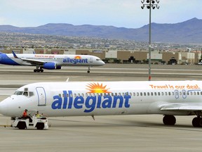 File - In this May 9, 2013, file photo, two Allegiant Air jets taxi at McCarran International Airport in Las Vegas. Shares of Allegiant Air's parent company are tumbling in Monday, April 16, 2018, premarket trading following a "60 Minutes" investigation that expressed serious safety concerns about the airline.