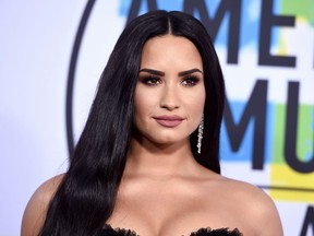 FILE - In this Nov. 19, 2017, file photo, Demi Lovato arrives at the American Music Awards at the Microsoft Theater in Los Angeles. Lovato ended the U.S. leg of her "Tell Me You Love Me" tour in a kiss with her opening act Kehlani. Kehlani sneaked on stage in Newark, N.J., on Monday, April 2, 2018, and grabbed Lovato, and the two shared a kiss.