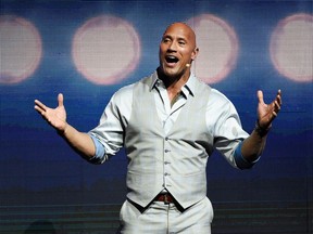 FILE - This March 28, 2017, file photo, Dwayne Johnson, a cast member in the upcoming film "Baywatch," addresses the audience during the Paramount Pictures presentation at CinemaCon 2017 in Las Vegas. Johnson said "depression never discriminates." The actor talks about his struggles with depression and his mother's suicide attempt after they were evicted in an interview with the Sunday Express.