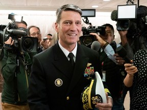 FILE - In this April 24, 2018, file photo, Rear Adm. Ronny Jackson, President Donald Trump's choice to be secretary of the Department of Veterans Affairs, leaves a Senate office building after meeting individually with some members of the committee that would vet him for the post, on Capitol Hill in Washington. Jackson is withdrawing from consideration as Veterans Affairs secretary. He said "false allegations" against him have become a distraction.