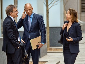 Attorney Joanna Hendon representing President Trump, right, talks to Michael Avenatti, attorney and spokesperson for adult film actress Stormy Daniels, center, at the Federal court, Friday, April 13, 2018, in New York. A hearing has been scheduled before U.S. District Judge Kimba Wood to address President  Trump's personal attorney, Michael Cohen's request for a temporary restraining order related to the judicial warrant that authorized a search of his Manhattan office, apartment and hotel room this week.