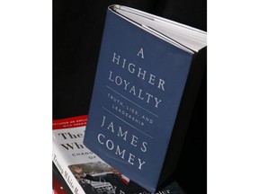 A copy of former FBI Director James Comey's new book, "A Higher Loyalty: Truth, Lies and Leadership," is on display, Friday, April 13, 2018, in New York. In the book, Comey compares U.S. President Donald Trump to a mob boss demanding loyalty, suggests he's unfit to lead and mocks the president's appearance.