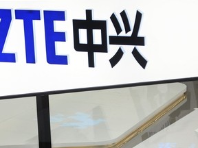 FILE- In this Feb. 26, 2014, file photo, a sign for the ZTE booth is seen at the Mobile World Congress, the world's largest mobile phone trade show in Barcelona, Spain.  The U.S. Commerce Department is blocking Chinese telecommunications giant ZTE Corp. from importing American components for seven years, accusing the company of misleading U.S. regulators after it settled charges of violating sanctions against North Korea and Iran.