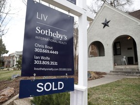 In this Wednesday, March 28, 2018, photo a sold sign is shown outside a single-family home on the market in Denver. On Thursday, April 5, Freddie Mac reports on this week's average U.S. mortgage rates.