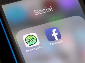 FILE- In this Feb. 16, 2018, file photo, Facebook and Facebook's Messenger Kids app icons are displayed on an iPhone in New York. Facebook is adding a "sleep" mode to its Messenger Kids service so parents can limit how much time children spend on it.