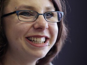 FILE - In this June 26, 2014, file photo, Michelle Knight smiles during an interview in Cleveland. Knight , one of three women who escaped a Cleveland home after being held for a decade has revealed she's married.  Knight announced on "Dr. Phil" that she has been happily married since May 2016. The episode, in which she promotes her book, "Life After Darkness," is scheduled to air April 24, 2018.