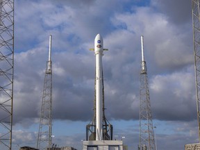 In this image released by SpaceX, NASA' s Transiting Exoplanet Survey Satellite (Tess) sits atop a SpaceX Falcon 9 rocket at Space Launch Complex 40, Monday, April 16, 2018, in Cape Canaveral, Fla. NASA's newest planet-hunting spacecraft is poised for a Monday evening launch. The Tess satellite will survey almost the entire sky, staring at the brightest, closest stars in an effort to find any planets that might be encircling them. (SpaceX via AP)