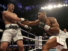 Anthony Joshua, right, battles against Joseph Parker during their WBA, IBF and WBO heavyweight champion at the Principality Stadium in Cardiff, Wales, Saturday March 31, 2018.