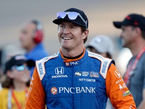 FILE - In this Saturday, April 7, 2018, file photo, driver Scott Dixon smiles before the IndyCar auto race at Phoenix International Raceway in Avondale, Ariz. Dixon will be the latest IndyCar driver to enter the realm of reality TV when he auditions in Indianapolis next week for "American Ninja Warrior.