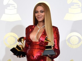 FILE - In this Feb. 12, 2017 file photo, Beyonce poses in the press room with the awards for best music video for "Formation" and best urban contemporary album for "Lemonade" at the 59th annual Grammy Awards in Los Angeles.Beyonce paid tribute to historically black colleges during her groundbreaking Coachella performance, and now the singer is donating $100,000 to four black universities. The superstar singer on Monday announced the Homecoming Scholars Award Program for the 2018-2019 academic year through her BeyGOOD initiative.
