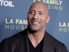 FILE - In this April 5, 2018 file photo, Dwayne Johnson attends the 2018 LA Family Housing Awards in West Hollywood, Calif. Johnson announced the birth of his third daughter Monday, April 23, on Instagram. He showed off a chest full of tattoos in a hospital snap with his latest addition, Tiana Gia Johnson. It's his second daughter with partner Lauren Hashian. He also has a 16-year-old daughter with his former wife, Dany Garcia. He said Hashian labored like a "rock star."
