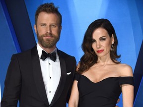 FILE - In this Nov. 8, 2017 file photo, Dierks Bentley, left, and his wife Cassidy Black arrive at the 51st annual CMA Awards in Nashville, Tenn. Bentley hopes that his new single reminds people that he's not always singing about being drunk on a plane, or being a beach bum looking for a rebound. Bentley will perform his new song, "Woman, Amen," at the Academy of Country Music Awards in Las Vegas on April 15.
