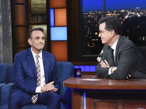 In this April 24, 2018 photo released by CBS, actor Hank Azaria, left appears with host Stephen Colbert on "The Late Show with Stephen Colbert," in New York. Azaria is ready to stop voicing Kwik-E-Mart owner Apu on "The Simpsons" in the wake of criticism that it is a stereotype. Azaria on Tuesday's "The Late Show with Stephen Colbert" says he hopes the animated show makes a change and he's willing to step aside if necessary.