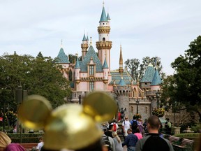 FILE - In this Jan. 22, 2015 file photo, visitors walk toward Sleeping Beauty's Castle at Disneyland Resort in Anaheim, Calif. Authorities say thieves made off with 8,000 Disneyland tickets when they stole a box trailer from a youth agricultural education organization. The California Highway Patrol says the trailer is owned by Future Farmers of America and was stolen Wednesday, April 18, 2018, from the group's office in the city of Galt, south of Sacramento.