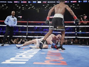 Daniel Jacobs walks away from Poland's Maciej Sulecki after knocking him down during the 12th round of a middleweight boxing match early Sunday, April 29, 2018, in New York. Jacobs won the fight.