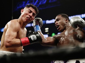 Adrien Broner, right, punches Jessie Vargas during the fourth round of a welterweight boxing match Saturday, April 21, 2018, in New York.