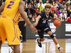 In this April 1, 2016, photo, La Lumiere's Brian Bowen (20) in action against Montverde Academy in the DICK'S Sporting Goods High School National Basketball Tournament in Queens, NY. La Lumiere won the game. South Carolina forward and former Louisville recruit Bowen is entering the NBA draft. The school announced Wednesday, April 18, 2018, Bowen won't hire an agent so he could return next season. Bowen transferred to South Carolina amid a federal investigation and has never been cleared by the NCAA to play.