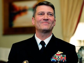 FILE - In this April 16, 2018, file photo, U.S. Navy Rear Adm. Ronny Jackson, M.D., left, sits with Sen. Johnny Isakson, R-Ga., chairman of the Veteran's Affairs Committee, before their meeting on Capitol Hill in Washington. Jackson, who abandoned his nomination to be secretary of Veterans Affairs amid numerous allegations, will not return to the job of President Donald Trump's personal physician but will remain on the White House medical staff, Politico reported Sunday, April 29.