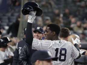New York Yankees' Didi Gregorius (18) raises his batting helmet to the crowd after hitting a solo home run, his second of the game, against the Miami Marlins during the seventh inning of a baseball game, Monday, April 16, 2018, in New York.