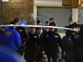 Officers arrive at the scene where police shot and killed a man in the Crown Heights section of Brooklyn, Wednesday, April 4, 2018, in New York, as they responded to reports of a man threatening people with a gun.