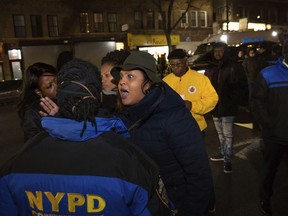 Sandy Michelin, an aunt of Kimani Gray, who was fatally shot by police in 2013, shouts at officers after police shot and killed a man in the Crown Heights neighborhood of Brooklyn, Wednesday, April 4, 2018, in New York, while responding to reports of a man threatening people with a gun.