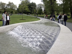 FILE - In this May 6, 2005, file photo, members of the public visit the "Diana, Princess of Wales Memorial Fountain," which was re-opened following four months of repairs, in London's Hyde Park. Fans of the British royals will want to include castles, Westminster Cathedral and other sites connected to Queen Elizabeth II and her family on any trip to England.