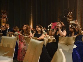 This July 7, 2016 photo provided by Erum Rizvi Photography shows guests who traveled from Singapore, India and the United States gathered at a table watching the entrance of the bride and groom during the wedding reception of Namrata Dadlani and Trishul Ganglani at the Grand Hyatt Erawan, in Bangkok. Attending the destination wedding were guests from all over the world. Choosing a faraway destination for a wedding may sound romantic and exotic, but it can take a financial toll on loved ones who don't have the time or money to participate.