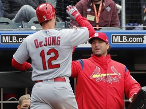 St. Louis Cardinals manager Mike Matheny, right, congratulate St. Louis Cardinals' Paul DeJong (12) after DeJone hit his ssecond home run of the day during the eighth inning of a baseball game against the New York Mets, Sunday, April 1, 2018, in New York.