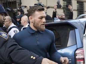 Ultimate fighting star Conor McGregor heads to a vehicle to leave Brooklyn Criminal Court, Friday, April 6, 2018 in New York. McGregor is facing criminal charges in the wake of a backstage melee he allegedly instigated that has forced the removal of three fights from UFC's biggest card of the year. Video footage appears to show the promotion's most bankable star throwing a hand truck at a bus full of fighters after a Thursday news conference for UFC 223 at Brooklyn's Barclays Center.