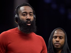 In this Nov. 18, 2017 photo, Houston Rockets guards James Harden, left, and Chris Paul warm up before and NBA basketball game against the Memphis Grizzlies in Memphis, Tenn. Chris Paul has a long history of playoff heartbreak. So does James Harden. And coach Mike D'Antoni has more than either of them combined. Separately, they've never gotten it done at playoff time. Together, their fortunes might change. They've led the Houston Rockets to the NBA's best record going into these playoffs. In a league that Golden State and Cleveland have dominated in recent years this might be the Paul-Harden-D'Antoni triumvirate that breaks through this spring.
