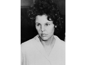 FILE - In this Oct. 21, 1981 file photo, Judith Clark is taken into police custody in Nanuet, N.Y. On Thursday, April 26, 2018, a New York judge has ordered a new parole hearing for the former radical anti-Vietnam War activist who drove a getaway car in a bungled 1981 Brinks heist that left three people dead. The board denied Clark parole a year ago.