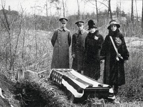 This 1926 photo provided by the Daughters of the American Revolution (DAR) shows a casket that was exhumed by the DAR on the estate of banker J.P. Morgan in Highland Falls, N.Y., with two women who were DAR researchers, right, and two Army officers, left, to serve as pall bearers. The casket, which was reburied at the U.S. Military Academy in West Point, was thought to contain the remains of Revolutionary War hero Margaret "Captain Molly" Corbin who stepped in to fire a cannon after her husband was killed in battle, but high-tech tests on the exhumed remains show they belonged to an unidentified male. (Daughters of the American Revolution via AP)