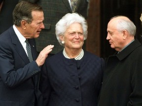 FILE - In this Nov. 8, 1999, file photo, former U.S. President George H.W. Bush, left, chats with former Soviet leader Mikhail Gorbachev, right, as Barbara Bush looks on before Bush was awarded the honorary citizenship of Berlin. A family spokesman said Tuesday, April 17, 2018, that former first lady Barbara Bush has died at the age of 92.